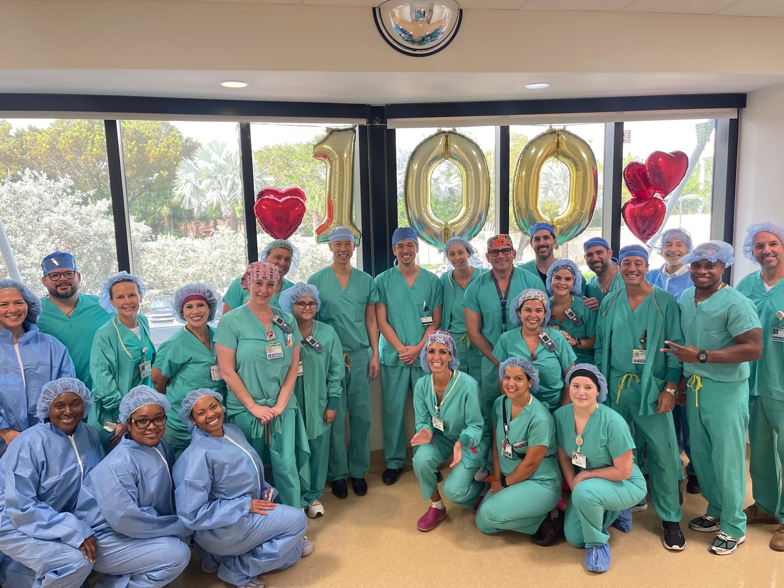 Group in scrubs with red balloons