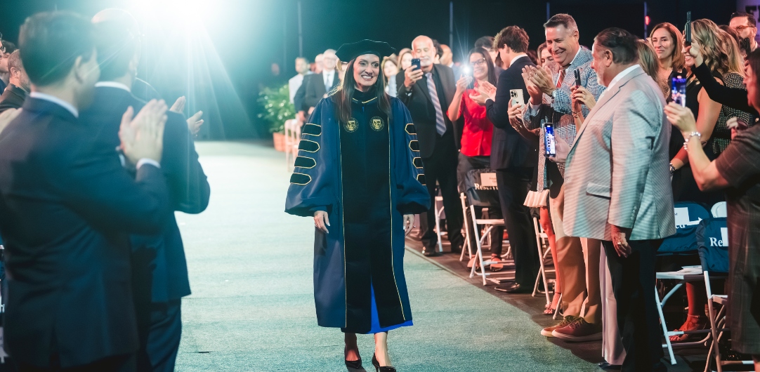 President Jeanette M. Nuñez walks into the auditorium