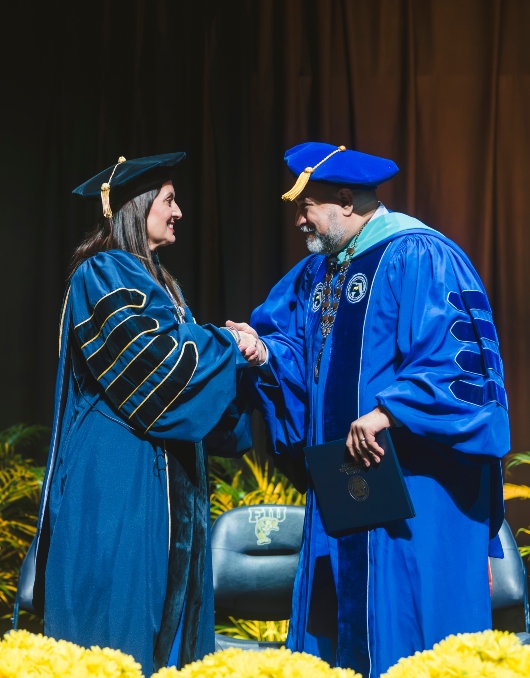 President Jeanette M. Nuñez shaking hands with Board of Governors Chancellor Raymond Rodrigues