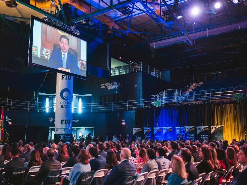 Recorded remarks from Gov. Ron DeSantis playing on the screen during the ceremony.
