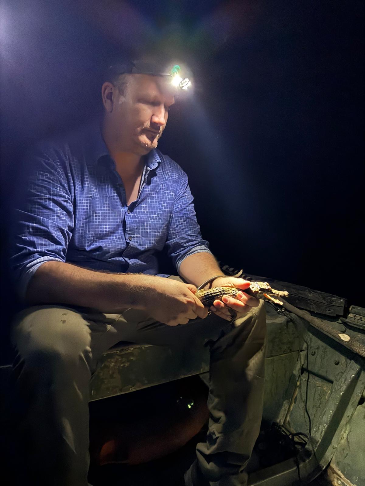 Matthew Shirley with a dwarf crocodile in Africa.
