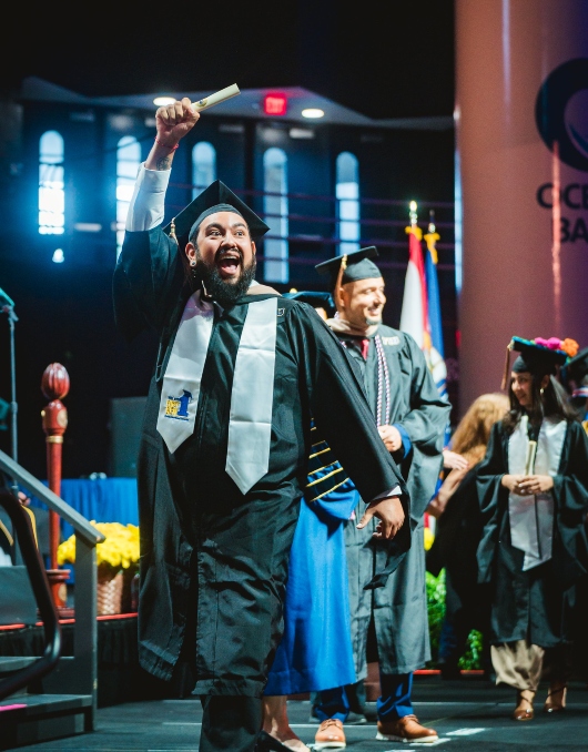 Student celebrating with his diploma