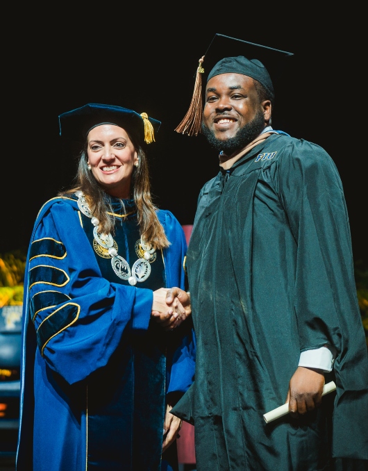 FIU President Jeanette M. Nuñez with student