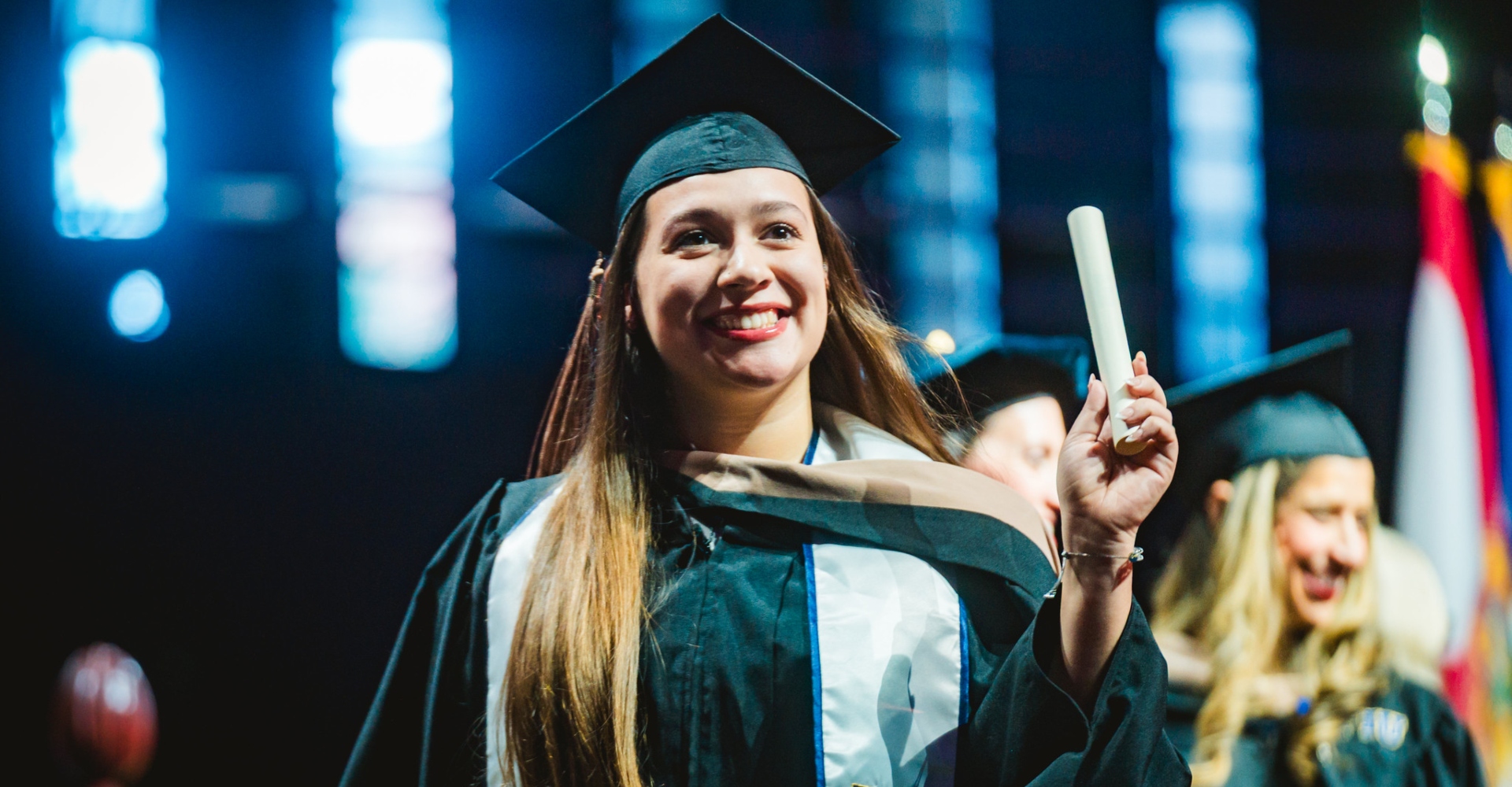 Student holding up diploma