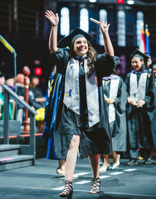 Student celebrating with her diploma