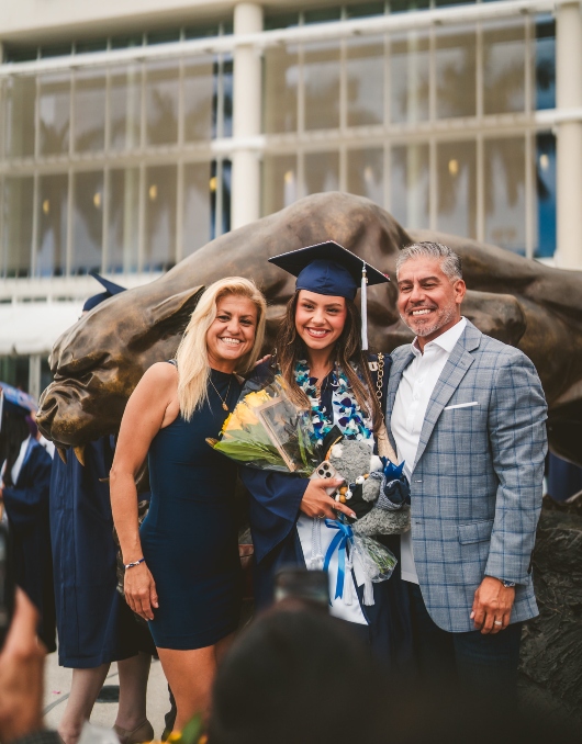 Graduate celebrating with parents