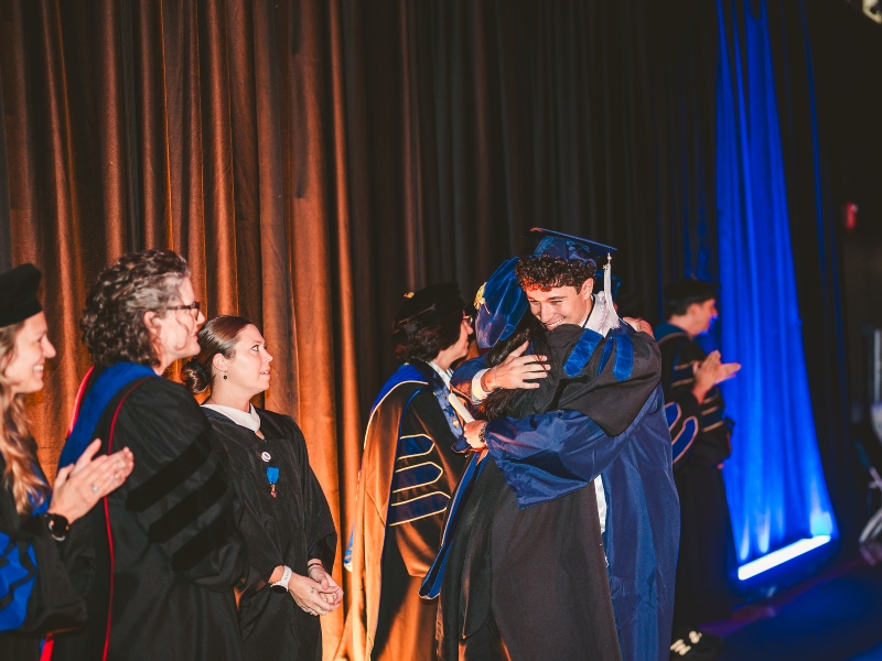Graduate celebrating with a faculty member