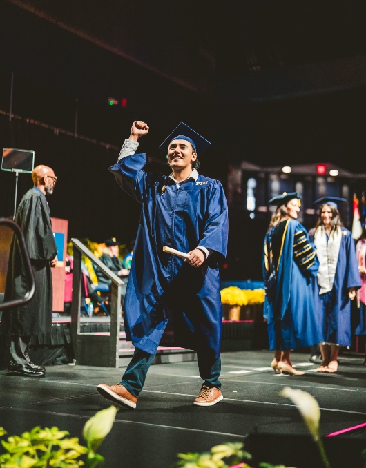 Student celebrating with his diploma