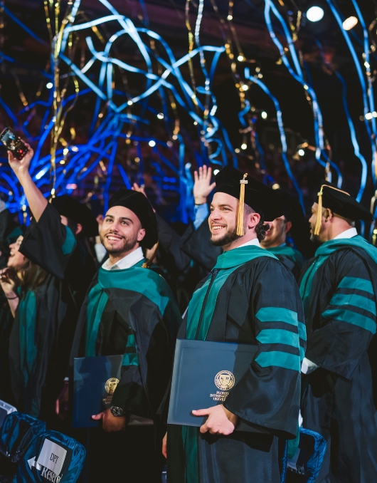 Graduate celebrating with diploma