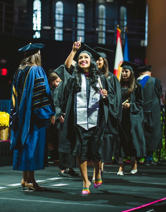 Student celebrating and pointing upwards to God in thanksgiving