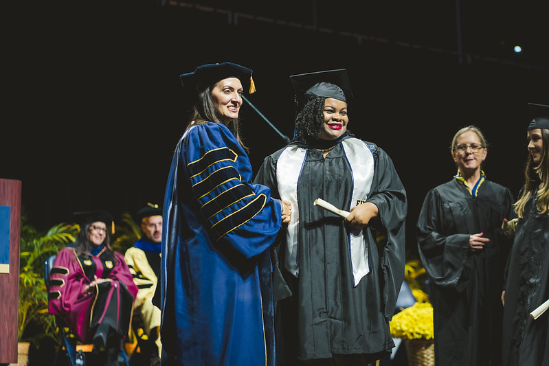 Walters-Brown (right) receiving her diploma from Jeanette M. Nunez, FIU's 7th President.
