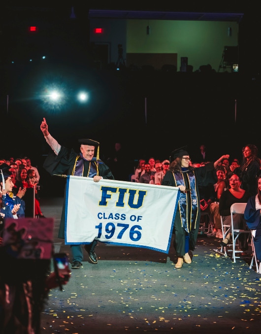Members of the Class of 1976 bringing in the banner during commencement
