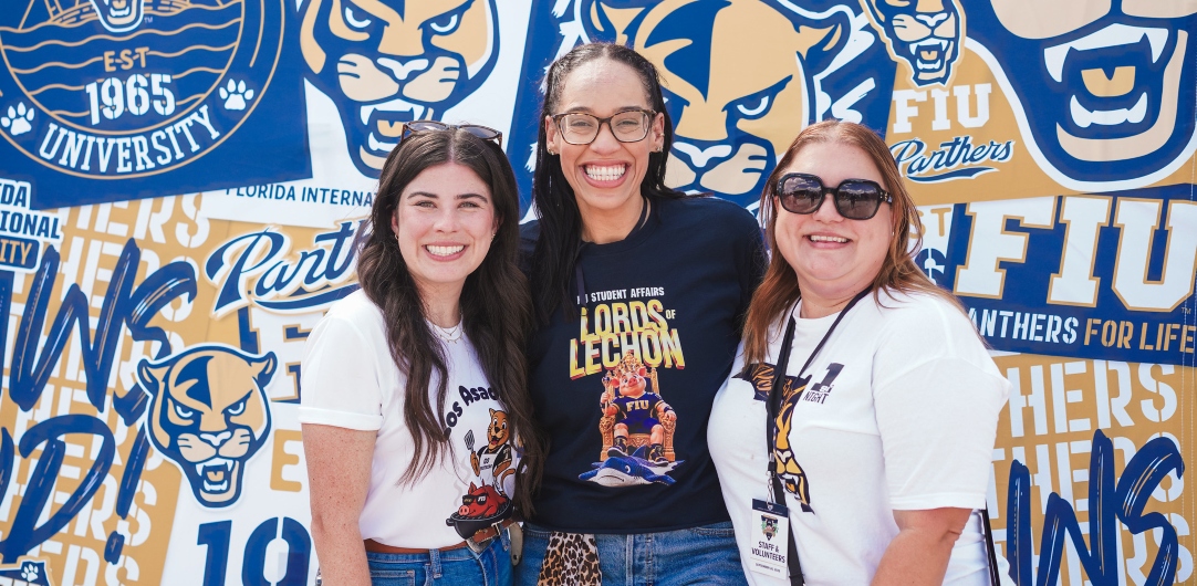 Staff members pose during the tailgate