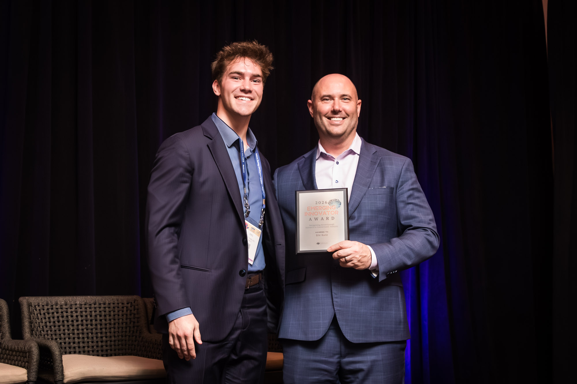 Eric Kunz (left) receives the 2026 Emerging Innovator Award at the Connectomics Circle Summit during the American Association of Neurological Surgeons Annual Meeting in San Antonio. Pictured with Peter Fecci, M.D., Ph.D., the summit’s master of ceremonies.