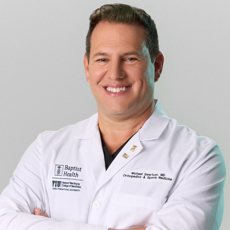 Professional headshot of Dr. Michael Swartzon in white coat.
