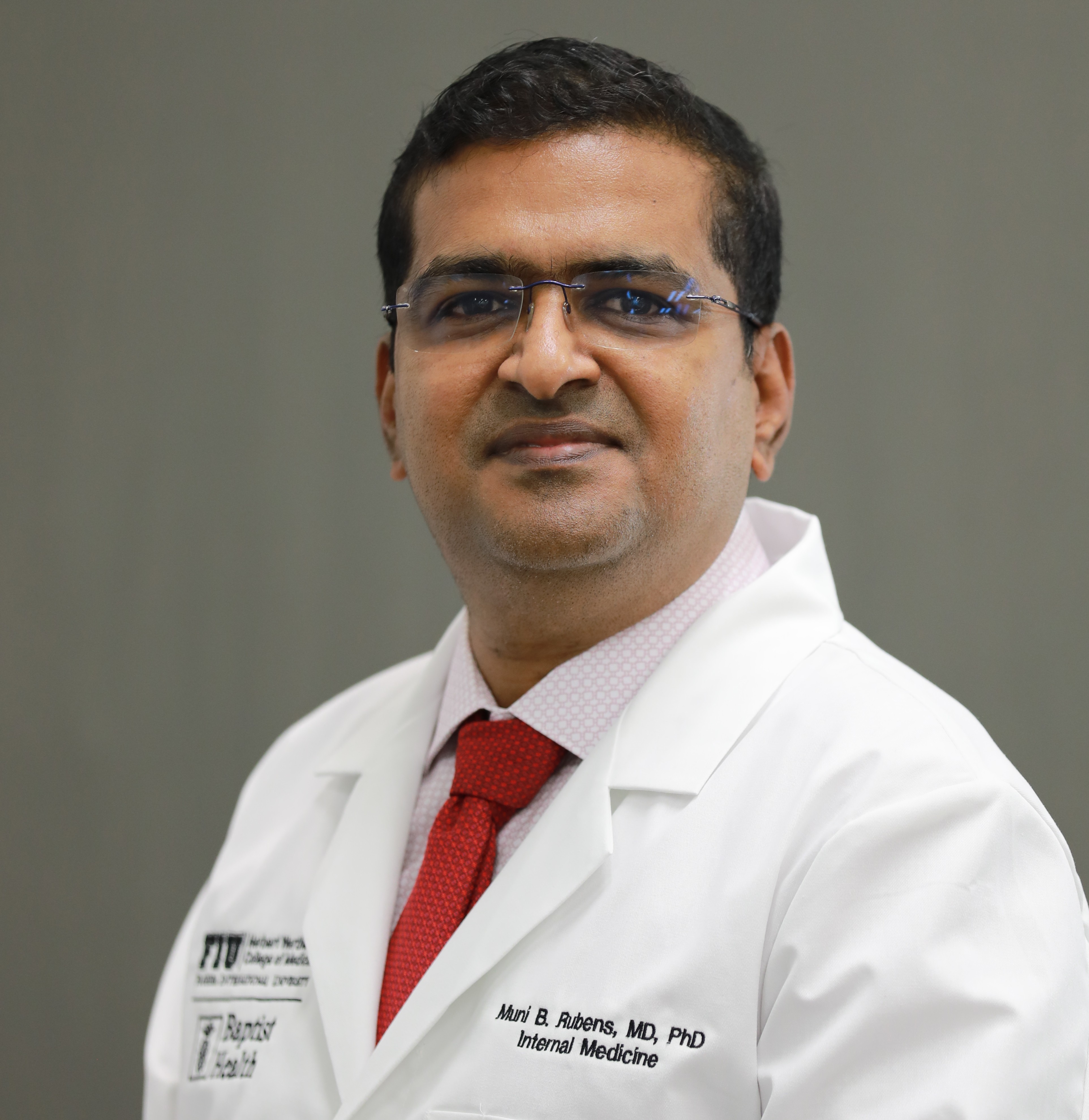Professional headshot of Dr. Muni Rubens