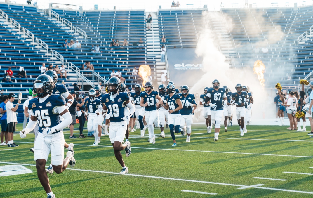 Football players running onto field