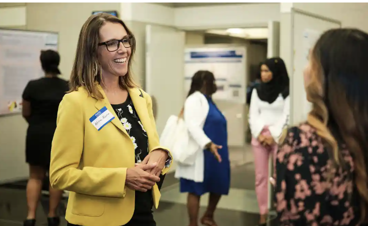 Alicia M. Alvero talking with students at CUNY