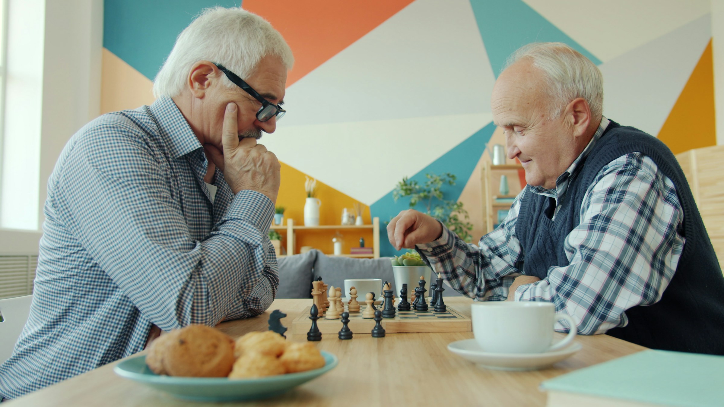 Two friends playing chess together